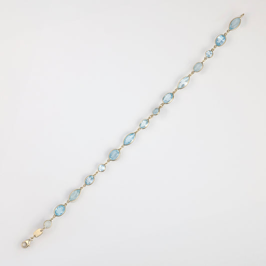 Marks Estate Department Fancy Link Blue Topaz Bracelet in 14 Karat Yellow Gold with 15 Various Shapes Blue Topazes 4.69mm-10.02mm